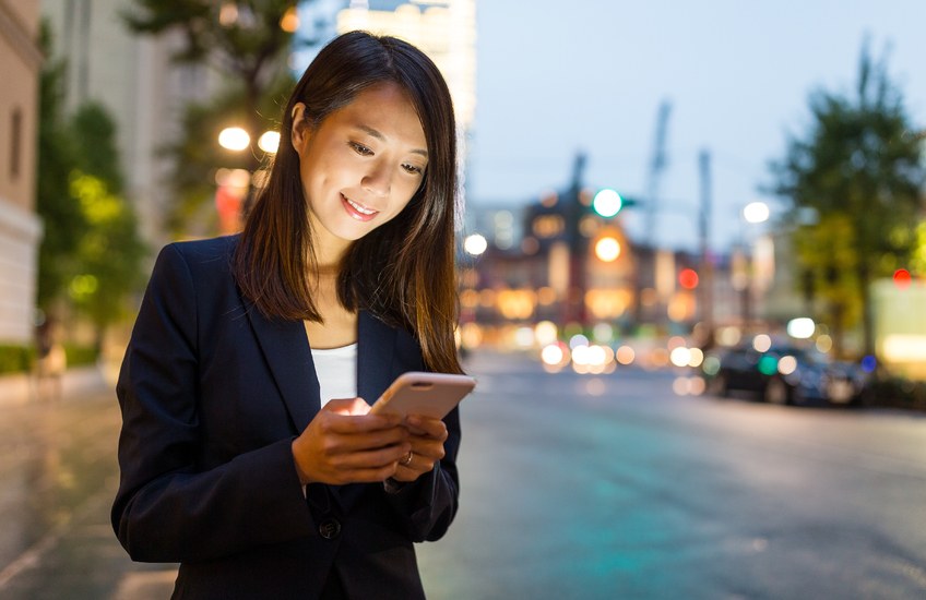 Joven japonesa consultando su teléfono móvil